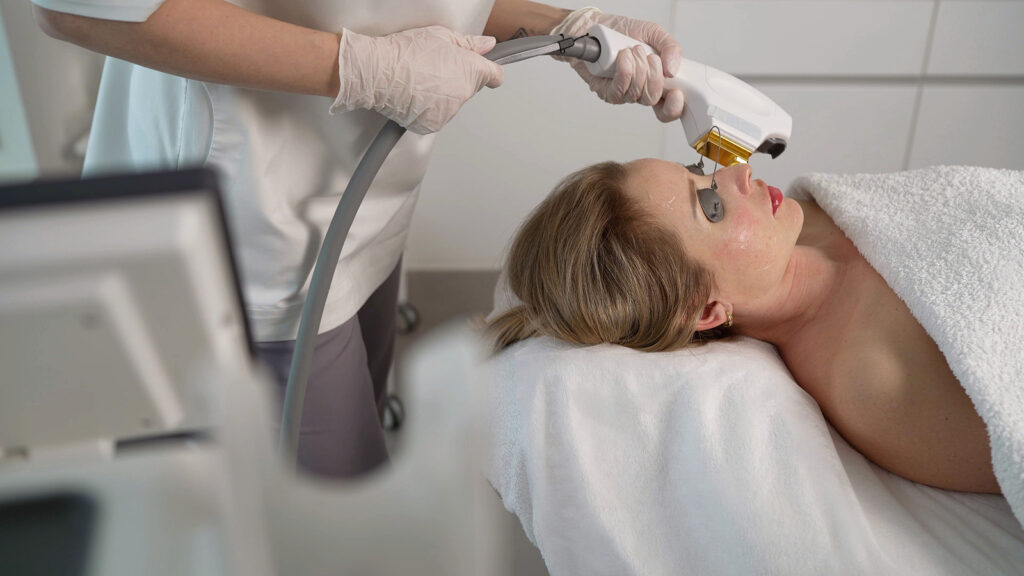 Beauty Clinic: Laser Therapy. Professional Beautician Removes Sp